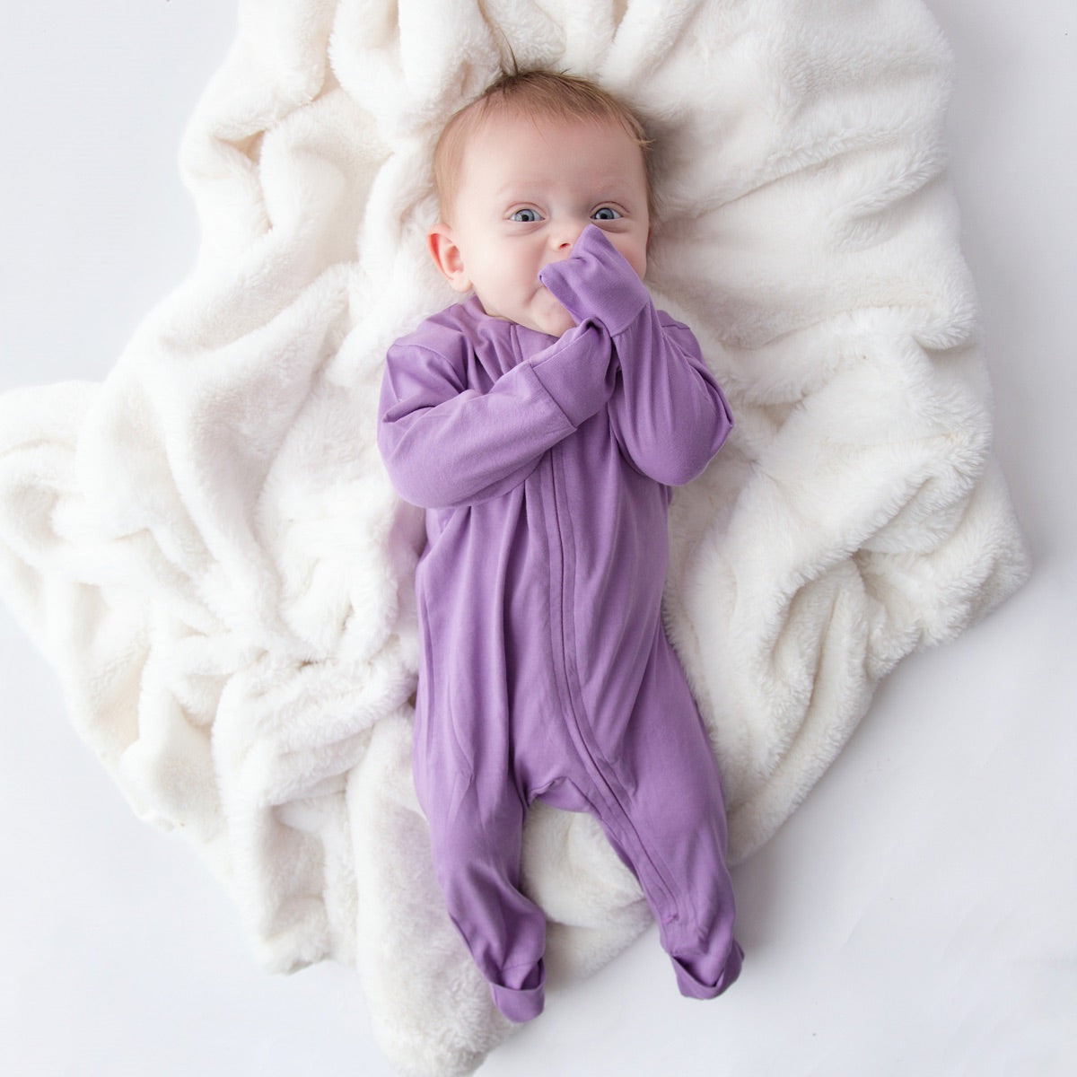 Baby wearing a Dawn Romper with the fold-over cuffs closed